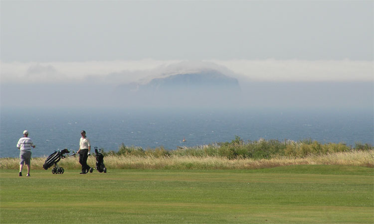 Numerous golf courses around Edinburgh and the Lothians offer varied scenery - here at Dunbar with a view to Bass Rock through the Haar.