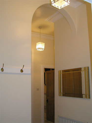 Hallway from entrance door view to back bedroom and kitchen
