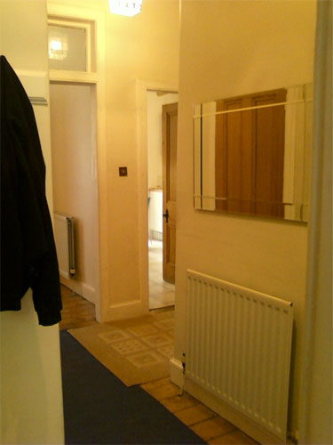 Hallway from entrance door view to back bedroom and kitchen