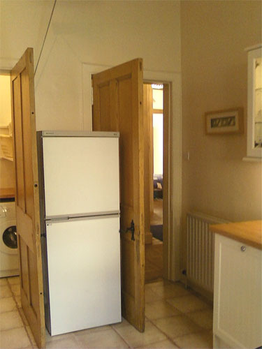Fridge freezer in kitchen, between doors to hallway and pantry