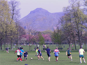 Playing on the meadows, with a view to Arthur's Seat